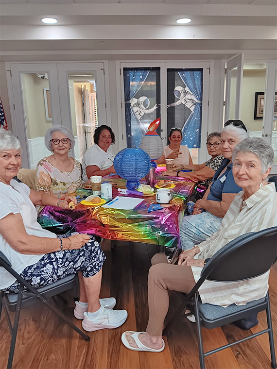 Guests gathered at a patriotic-themed table for the Stars, Stripes and Sips coffee morning